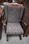 A vintage wing back rocking chair, possibly Parker Knoll