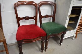 A pair of Victorian rail back dining chairs having turned legs