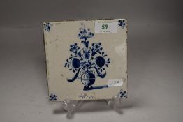 A 18th century Dutch delft tile depicting a floral vase of flowers