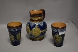 A Victorian Doulton Lambeth glazed jug and two beakers , celebrating Queen Victoria 60th Jubilee,