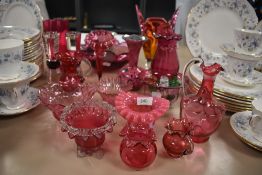 A selection of cranberry glass and similarly styled jugs,vases and bowls.