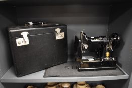 A 1950s Singer sewing machine, model 222K, serial number EK326470, with original case and manual