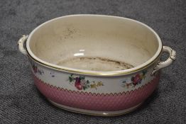 A late 19th or early 20th Century Minton's footbath of two handled oval form with floral transfer