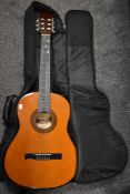 A Stagg classical guitar and a padded gig bag