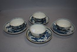 A group of four 18th century English porcelain teabowls and saucers, printed in under glaze blue