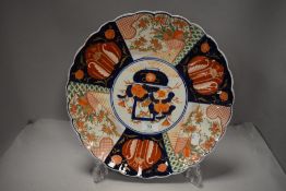 An antique Japanese porcelain plate in an Imari palette with traditional design