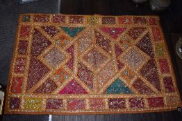 A decorative Indian or similar wall hanging or throw having extensive sequinned beads and metal