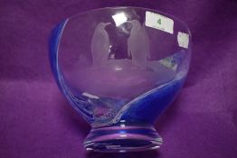 A modern art glass fruit bowl having ocean effect splash with etched penguin and fish design