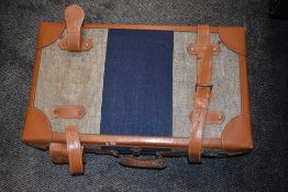 A vintage style suitcase, tweed style and leather finish