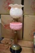An impressive antique oil lamp, converted to electric with opaque shade and pink vaseline glass