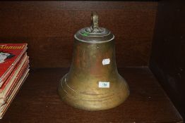 A large brass bell, possibly from ship or factory