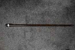 A plain form walking cane in a club style made from black palm wood