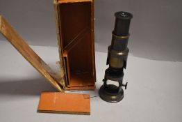 A vintage College microscope in original case