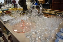 A selection of vintage cut and pressed glass including tumblers,cake plate,decanters and more.