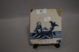 A 18th century Dutch delft tile depicting a mythical sea creature or mermaid