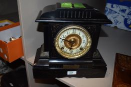 A late Victorian cold painted mantel clock having enamel face with bevelled glass door.