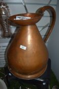 A large two gallon copper water jug