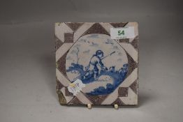 A 18th century Dutch delft tile depicting a farm worker or peasant working the land