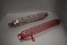 Two late Victorian glass confectionary rolling pins having coloured glass designs