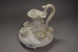 A mid 19th century Derby Blanc de Chine ewer, having rose encrusted body, Stevenson,sharp and Co