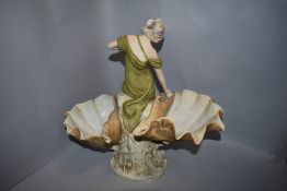 A Royal Dux figurine,circa 1918, depicting classically dressed maiden between two up turned shells