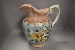 A late 19th or early 20th Century wash jug having gilt heightened daffodil decoration
