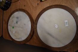 A pair of marble and treen revolving cake stands in the lazy susan style