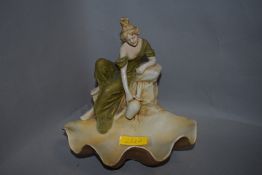 A Royal Dux figurine,Circa 1918, depicting classically dressed maiden with jug and upturned shell,
