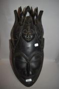 A large carved wooden tribal African or similar mask.