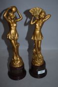 A pair of art deco mantle garniture figures of flapper girls in dress solid cast with bakelite