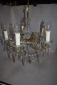 A five branch candelabra having cut glass arms with lustre droplets