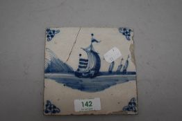 A 18th century Dutch delft tile depicting a sailing galleon at sea