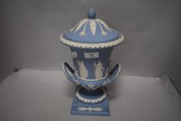 An early 20th century Wedgwood Jasperware twin handle and lidded mantle urn with Grecian design