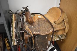 An American style leather tooled and carved horse saddle sheep skin lined with bridal, American