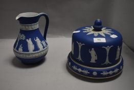 A Wedgwood jasperware cheese dome and jug, typical classical maiden decoration