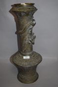 A Chinese Qing dynasty bronze temple vase having dragon figure to neck and dragon panels