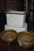 A ceramic planter in a basket design and two brass planters