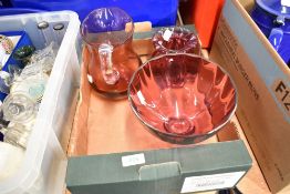 A selection of cranberry glass wares including footed comport and water jug