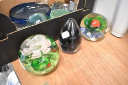 Three modern paper weights one by Wedgwood and two having floral lamp work designs