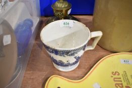 A large blue and white ware cup or mug with a traditional printed scene