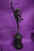 A Victorian bronze figure sculpture of Hermes with the head of Caduceus atop a plinth of cherubs