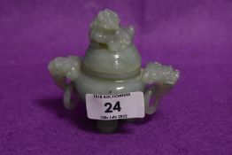 A Chinese or similar Jade stone hand carved three footed Koro having dog of Fo lid and twin dragon