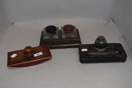 Two mid Victorian desk top ink well pen holders and a similar aged blotter