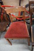 A Gordon Russell Ltd oak single chair with upholstered drop in seat, bearing manufacturers label.