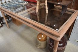 A large wood and glass dining table, approx 180 x 90cm