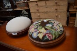A needlepoint foot rest and similar blank foot rest.