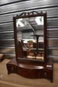 A late Georgian dressing table mirror having serpentine front and three drawers.