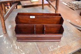 A modern mahogany stationery rack