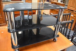 A modern black glass TV stand