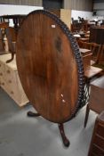 A Victorian loo table having oval tilt top with turned edging, on triple splay legs, approx. 130 x